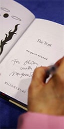 Margaret Atwood signing a book with  'The Long Pen'