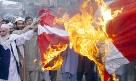 Protesters in Peshawar burn a Dutch flag in protest at the Muhammad cartoons