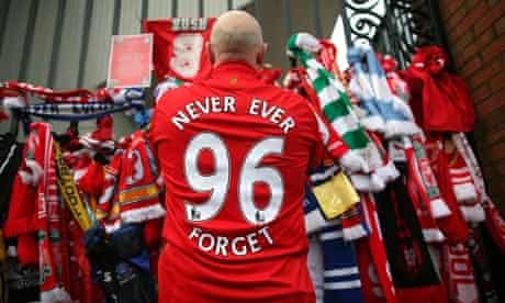 A Liverpool fan pays his respects at the Hillsborough memorial at Anfield