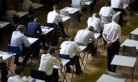 Schoolchildren sit an exam.