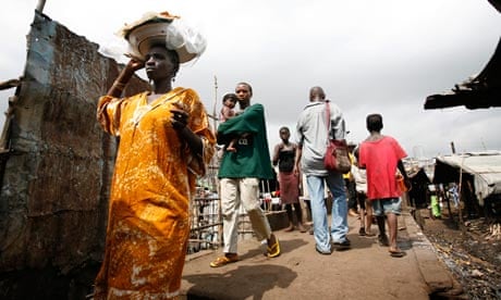 People walk in the slum area freetown