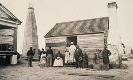 A group of slaves outside their quarters on a Georgia plantation.