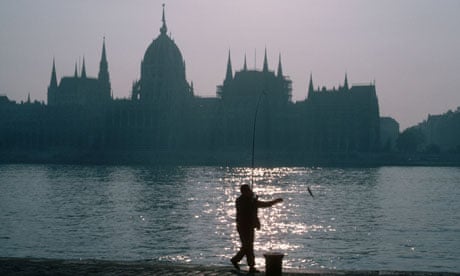 Ebb and flow ... a man fishes in the Danube opposite the Hungarian Parliament Building in Budapest.