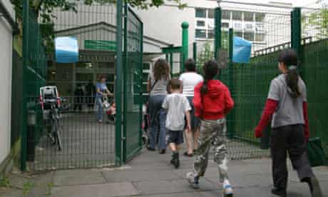 Parents and their children arrive at school 
