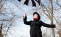 The Night Circus author Erin Morgenstern appearing to float with a black-and-white umbrella