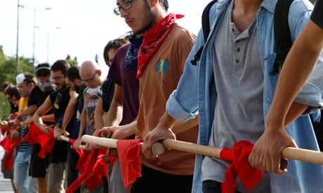 Greek students form a human chain during a protest march in Athens