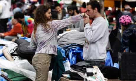Occupy Wall Street members clean up their campsites