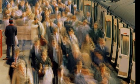 Commuters on railway station platform (blurred motion)