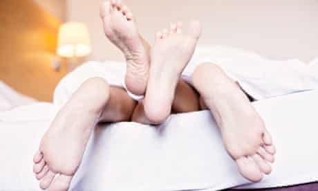 Feet of a couple in the bed