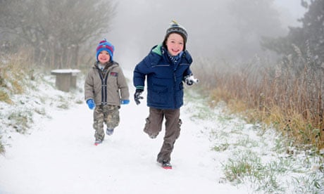 Children run through the snow at Sutton Bank near Thisk