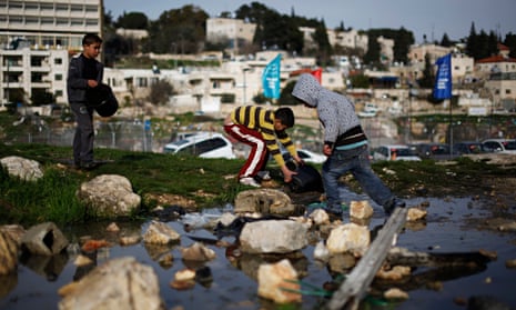 Palestinian children collect water in the Sheikh Jarrah neighbourhood in East Jerusalem.