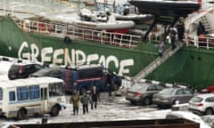 Arctic Sunrise's captain, Peter Willcox, is arrested and led from his ship in Murm
