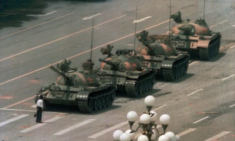 A pro-democracy protester blocks a line of tanks in Tiananmen Square on 4 June 1989.