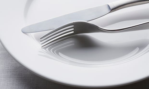 Knife and fork on empty white plate