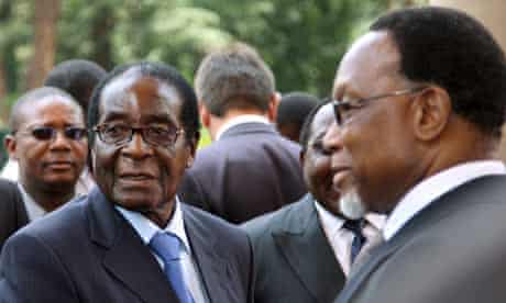 Robert Mugabe is welcomed by Kgalema Motlanthe in Pretoria
