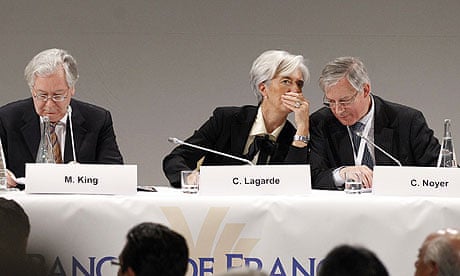IMF chief Christine Lagarde whispers to France's central bank governor Christian Noyer