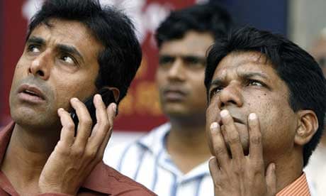 Indian investors watch share prices outside the Bombay Stock Exchange