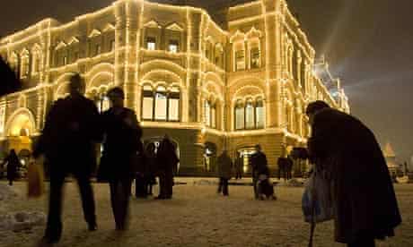 A woman begs near the GUM department store in Moscow's Red Square