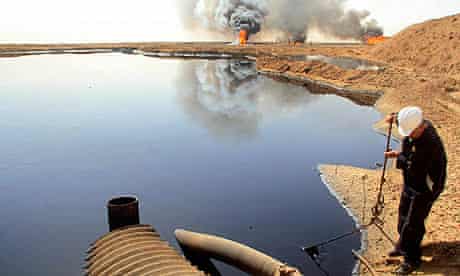 An Iraqi oil worker works at an oil field