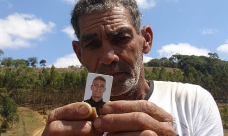 Antonio Ramos dos Santos holds up picture of son Herminio Cardoso dos Santos