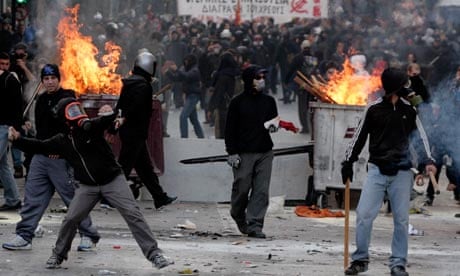 Flaming bins and masked protesters outside Athens parliament