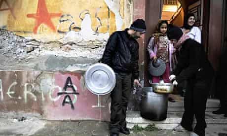 Soup kitchen activists deliver food to a poor area of Athens
