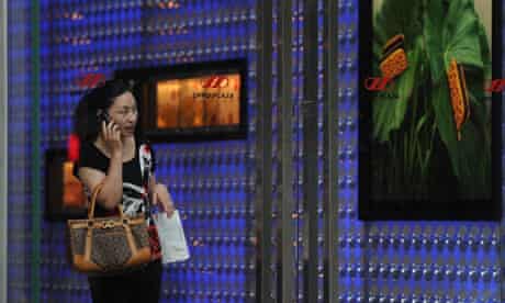 A woman leaves a luxury shopping mall in Shanghai