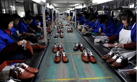 Employees work at a shoe factory in Lishui, Zhejiang province, China
