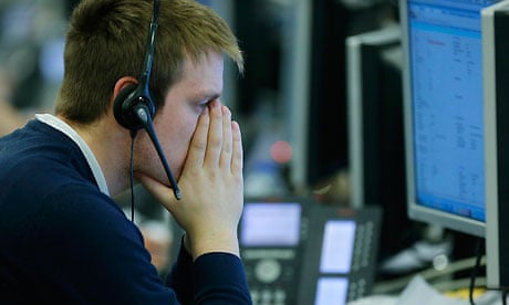 A broker at IG Index reacts as sterling tumbles