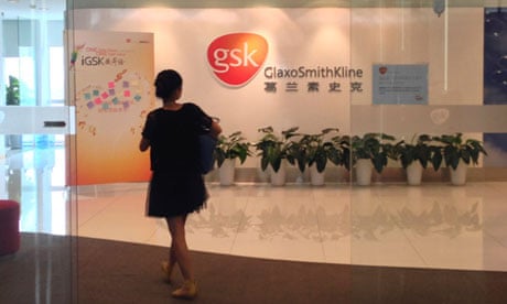 A Chinese employee walks into a GlaxoSmithKline (GSK) office in Beijing