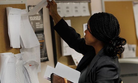 A US job-seeker looks over listings on a board at a New York State Employment Services office