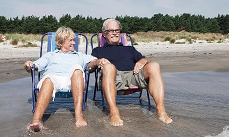Couple in sunloungers at the beach