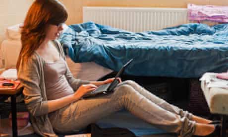 Student using laptop in her dorm room