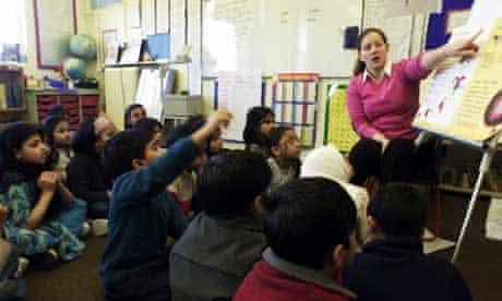 A teacher giving a lesson to pupils at Osami primary school in London