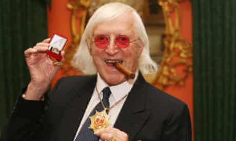 Sir Jimmy Savile after he received a commemorative badge from Prime Minister Gordon Brown