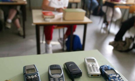 Students' mobiles switched off and left on a table during an exam