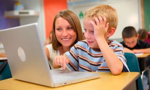 Teacher and school student working on laptop