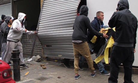 Youths loot a store in Hackney during the riots in London.