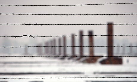 Chimneys seen through barbed wires at the Auschwitz-Birkenau death camp in Oswiecim