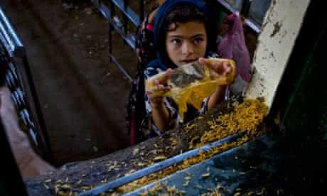 A little girl receives free food on World Food Day in 2010 in Islamabad, Pakistan