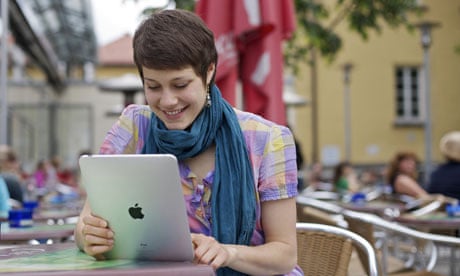 Girl student using ipad at cafe