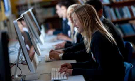 A teenage girl taking part in a computer science or ICT lesson at school.
