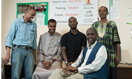 At the Islington Somali Community centre, tutor Abdullahi Awale sits with co-workers