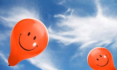 smiley face balloons in blue sky