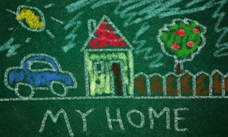 Child drawing of home on a green chalkboard