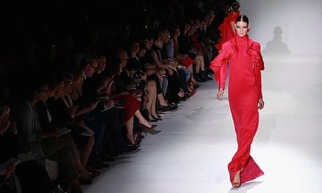 model in red dress on catwalk