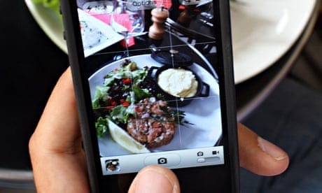 taking photograph of food on mobile phone