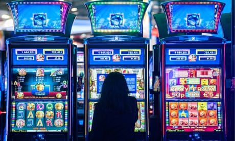 young woman at a slot machine gambling