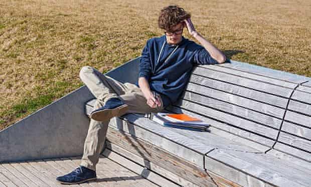 Teenage boy sitting on bench