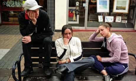 Group of young bored teenagers hanging around the shopping Centre at Kingston,  South London.